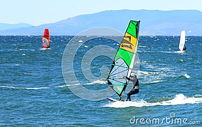 Surfers on a sunny autumn windy day in the waters of the Amur Bay in Vladivostok Editorial Stock Photo