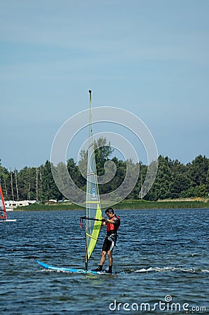 Surfers swimming on boards on the Puck Bay in poland on a warm summer day Editorial Stock Photo