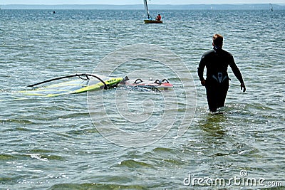 Surfers swimming on boards on the Puck Bay in poland on a warm summer day Editorial Stock Photo