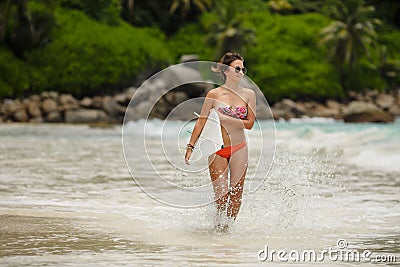 Surfing beautiful woman on the beach Stock Photo