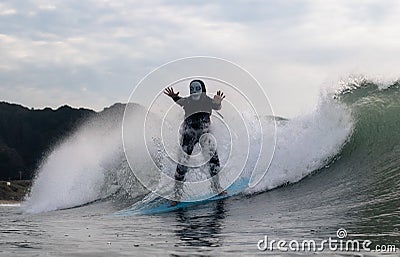 Surfing in Halloween Costumes in Chiba Japan. Scary suits like pumpkins and monsters. Stock Photo