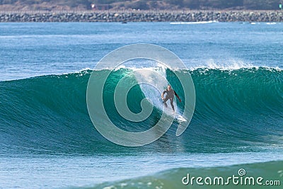 Surfing Surfer Rides Wave Stock Photo
