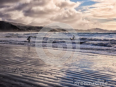 Surfing under a winter sunset Editorial Stock Photo