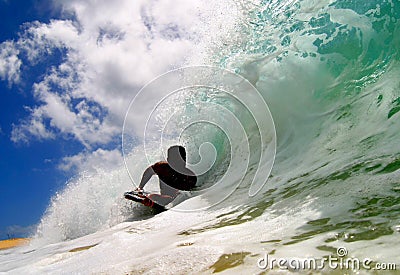 Surfing a Wave in Hawaii Stock Photo