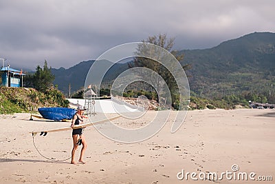 Surfing woman with surfing board on the beach Stock Photo