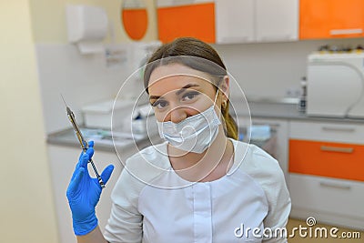 The surgeon dentist in mask holding syringe for injecting. Stock Photo