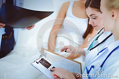 Surgeon and doctor analyzing x-ray together in medical office Stock Photo