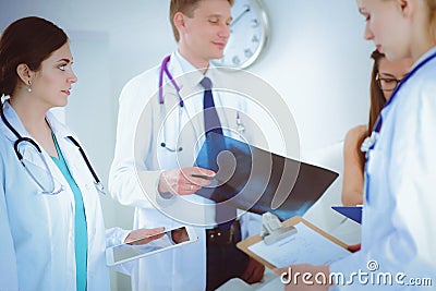 Surgeon and doctor analyzing x-ray together in medical office Stock Photo