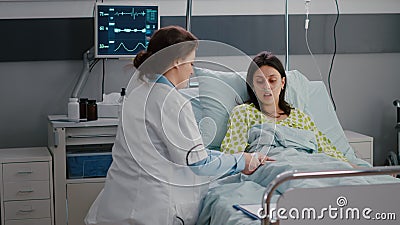 Surgeon doctor monitoring hospitalized sick woman during cardiology appointment Stock Photo