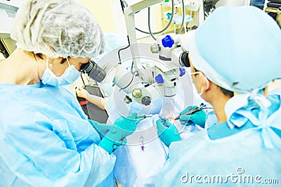Surgeon doctors in operation room Stock Photo