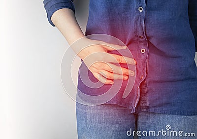 A woman suffers from pain in the appendix. Acute appendicitis, Crohn`s disease, or inflammatory bowel disease. Surgeon examination Stock Photo