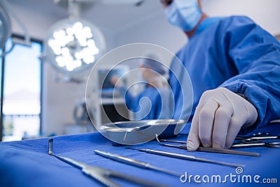 Surgeon holding surgical tool in operation theater Stock Photo