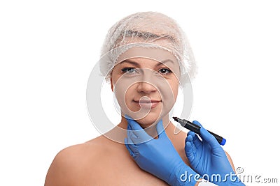 Surgeon with marker preparing woman for operation against background. Double chin removal Stock Photo