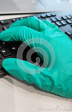 Surgeon surgical doctor on hygiene protective disinfection green glove typing keyboard, Researching and analysing in hospital labo Stock Photo