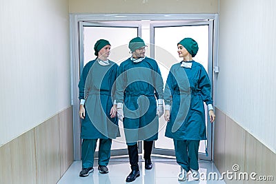 The surgeon team going from operating room go to fornt. The surgeon is walking out of the operating room Stock Photo