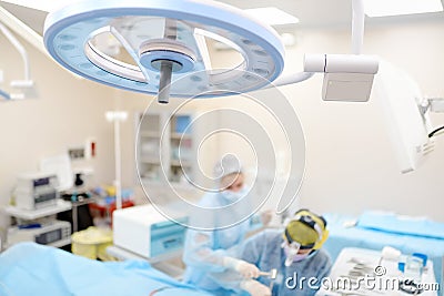 Surgeons are during maxillofacial operation using microscope and endoscope in modern hospital. Teamwork of doctors. Maxillofacial Stock Photo