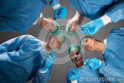 Surgeons With Medical Instruments Looking At Camera Stock Photo