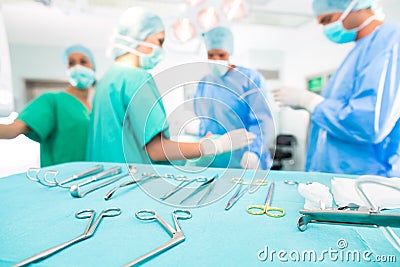 Surgeons operating patient in operating room Stock Photo