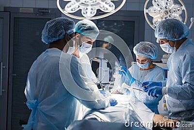 Surgeons perform a complex operation to save a human life at hospital Stock Photo