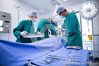 Surgeons performing operation in operation theater Stock Photo