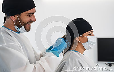 Surgeons smiling after a successful surgical operation - Medical workers the real heroes during corona virus outbreak Stock Photo