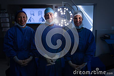 Surgeons standing in operation theater Stock Photo