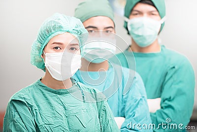 Surgeons team, man and woman wearing protective uniforms Stock Photo