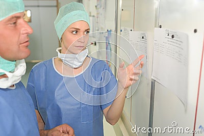 Surgeons team man and woman wearing protective uniforms Stock Photo