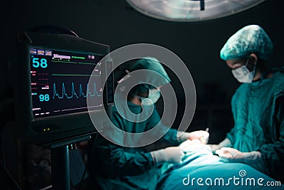 Surgeons team working with Monitoring of patient in surgical operating room Stock Photo