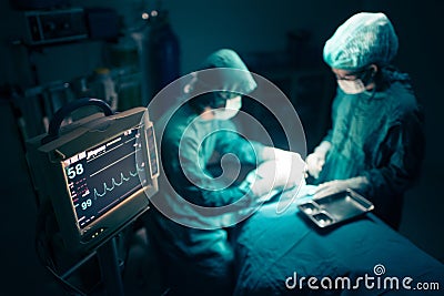 Surgeons team working with Monitoring of patient in surgical operating room. Stock Photo