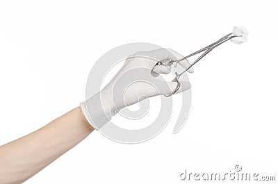 Surgery and medicine theme: doctor's hand in a white glove holding a surgical clamp with swab isolated on white background Stock Photo