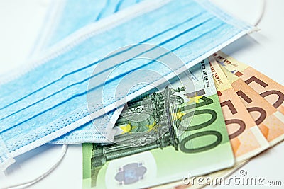Surgical face masks and Euro Banknotes, inflated export and import, mandatory masking Stock Photo