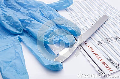 Surgical gloves, scalpel and hematology blood test result on operating table. Preparation for surgery or its completion. Physician Stock Photo