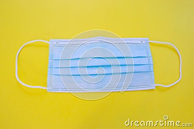 Surgical mask with rubber ear straps. Typical 3-ply surgical mask, against covid. Procedure mask from bacteria. Protection Stock Photo