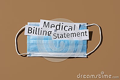Surgical mask and text medical billing statement Stock Photo