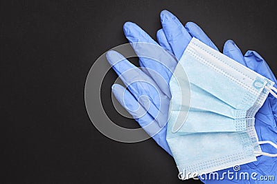 surgical protective tools face mask and latex gloves over black background with copy space. top view Stock Photo