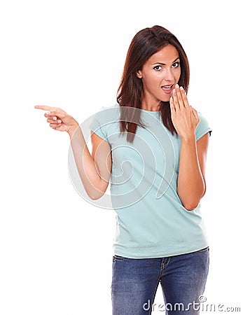 Surpriesed adult lady pointing to her right Stock Photo