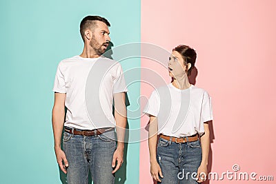Wow. Doubtful pensive couple with thoughtful expression making choice against pink background Stock Photo