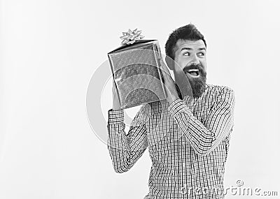 Surprise and holiday gift concept. Macho with wrapped blue gift Stock Photo
