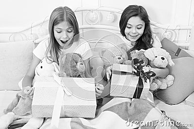 Surprise inside. Surprised children in morning. Little girls open present boxes in bed. Gift surprise. Receiving Stock Photo