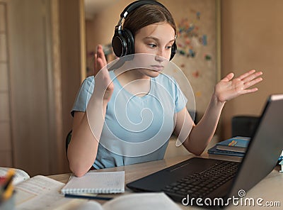 Surprise strange, misunderstanding, girl teenager, home confusion, headphones, laptop lessons, watching videos. E Stock Photo