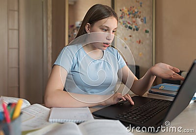 Surprise strange, misunderstanding, girl teenager, home confusion, laptop lessons, watching videos. E-education distance Stock Photo