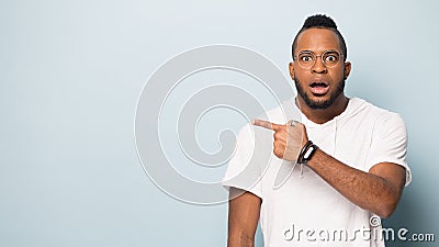 Surprised african American man point at blank copy space Stock Photo