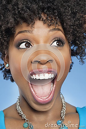 Surprised African American woman looking away with mouth open Stock Photo