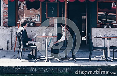 Surprised aged couple checking the bill in a restaurant - Expensive Restaurant Bill. - inspecting the check in italy Editorial Stock Photo