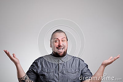 Surprised and amazed looking The man naively laid his hands in the sides. Stock Photo