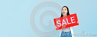 Surprised Asian woman holding sale sign Stock Photo