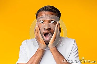 Surprised Black Man Touching Face Posing Over Orange Background Stock Photo