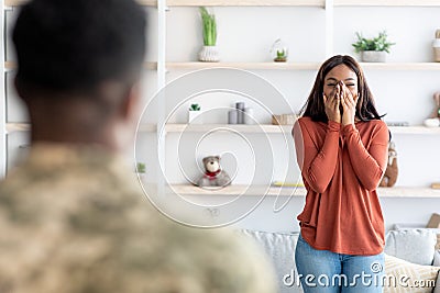 Surprised Black Wife Welcoming Soldier Husband At Home After Army Stock Photo