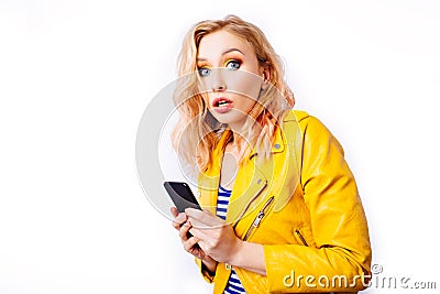 Surprised blonde girl with a smartphone Stock Photo